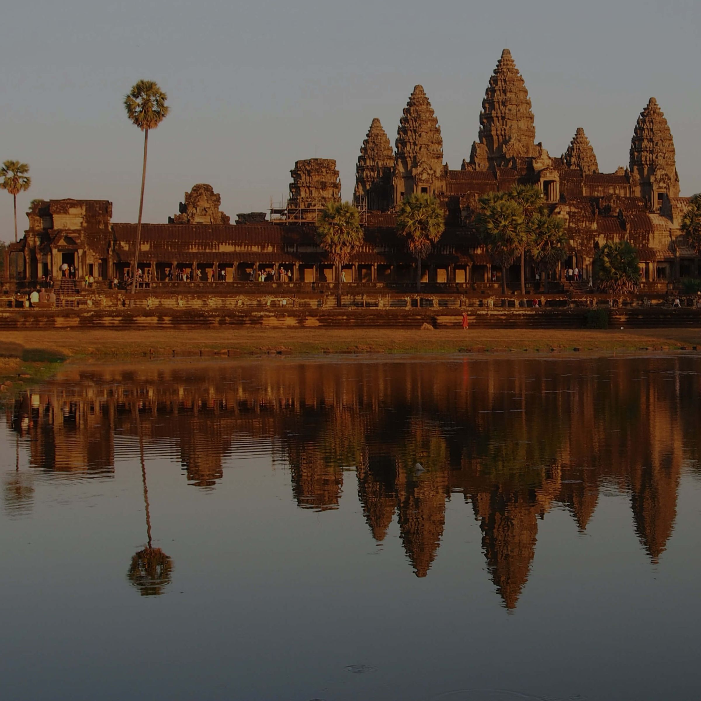 Angkor Wat reflected in still water at sunrise, Cambodia