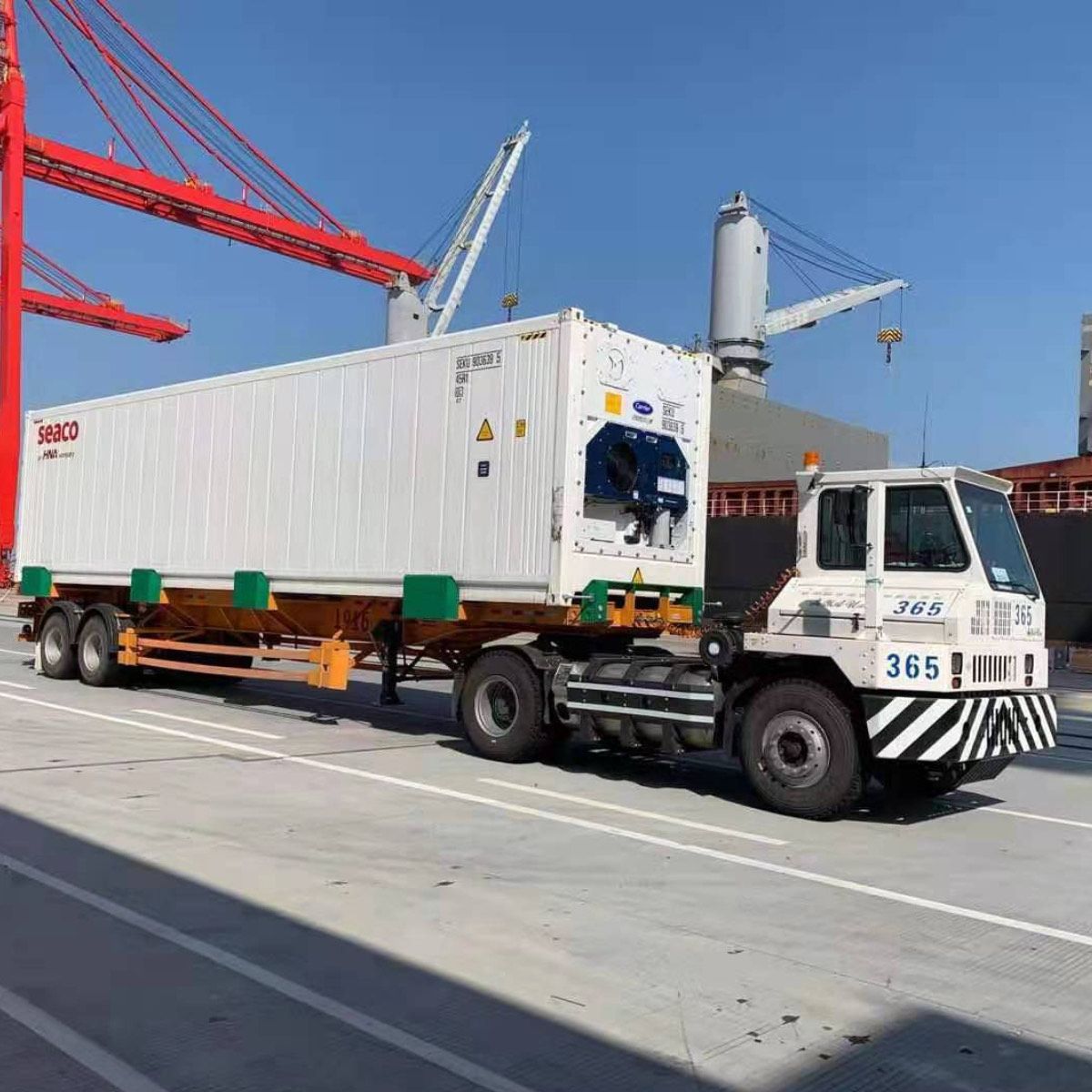 A refrigerated container on a terminal tractor at the quayside