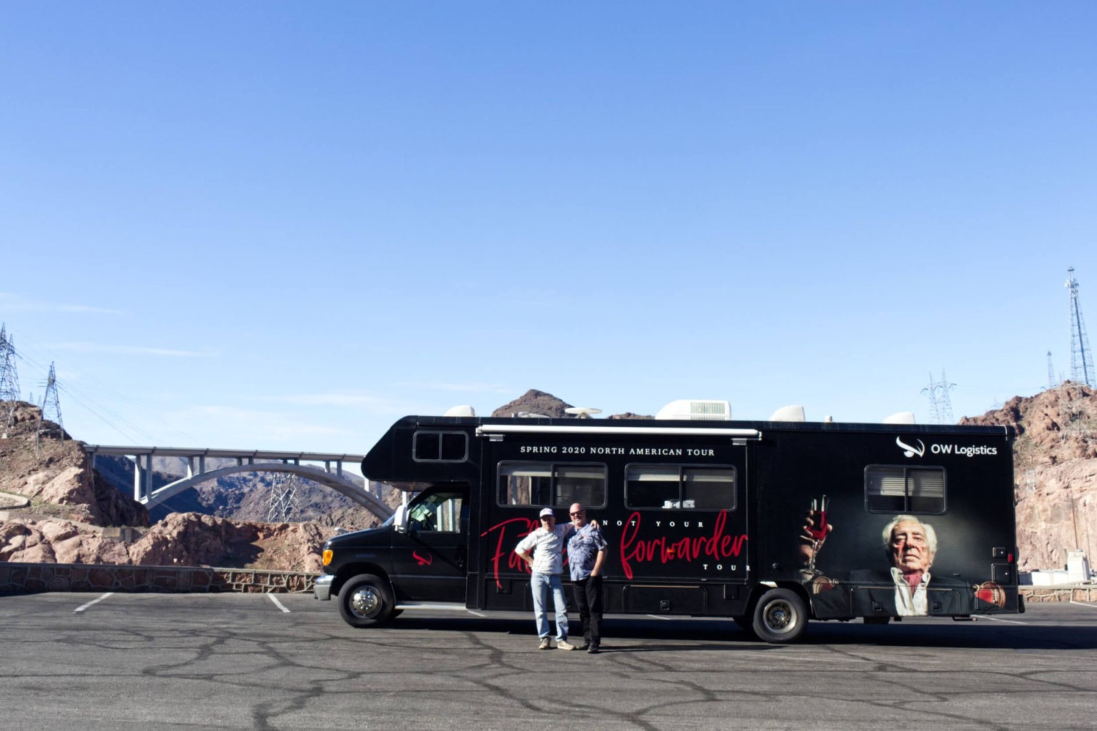 The OWL Never Ending Tour RV parked by the Hoover Dam bridge